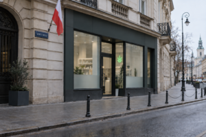 Medical cannabis dispensary on Nowy Świat in Warsaw, marked by a green cannabis leaf sign and Polish flag.